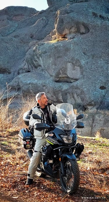 a man sitting on a motorcycle with a motorcycle